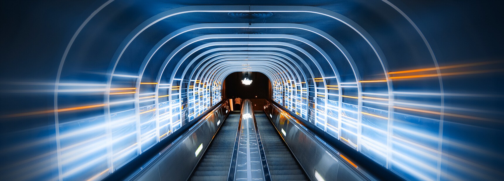 Illuminated escalator travelator tunnel