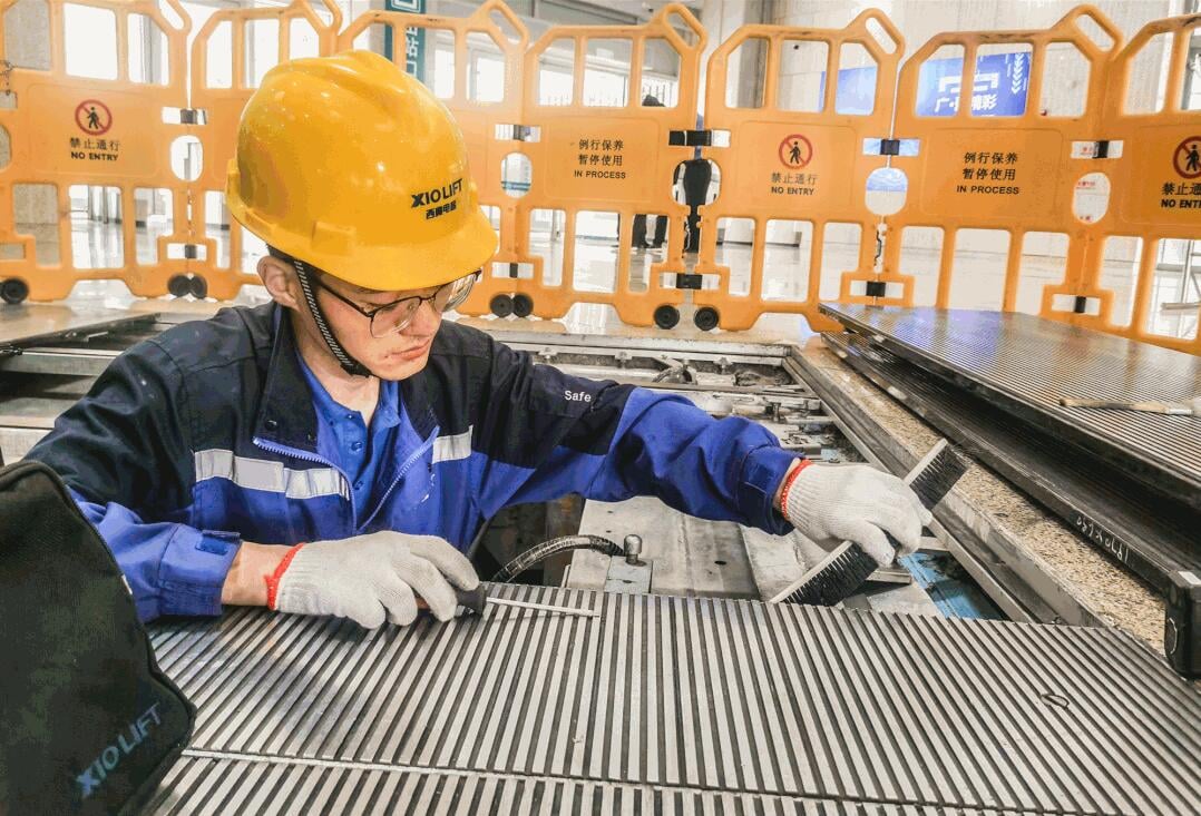 XIOLIFT technician working on a lift component